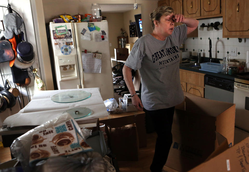 Woman taking break from moving furniture