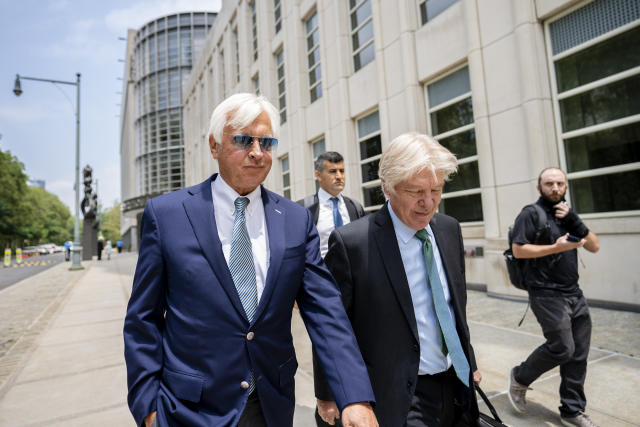 FILE - In this Monday, July 12, 2021 file photo, Horse trainer Bob Baffert, left, leaves federal court in the Brooklyn borough of New York. A New York federal judge on Wednesday, July 14, 2021 nullified the suspension of horse trainer Bob Baffert, finding that the New York Racing Association acted unconstitutionally by failing to let him adequately respond to claims made against him after Kentucky Derby winner Medina Spirit failed a postrace drug test.(AP Photo/John Minchillo, File)
