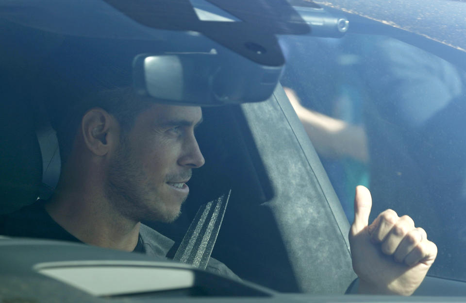 Soccer player Gareth Bale gestures to fans as he arrives at the training ground of Tottenham Hotspur in London, Friday Sept. 18, 2020. Real Madrid winger Gareth Bale is in London to complete his return to Tottenham. Bale left Tottenham for Madrid in 2013 for 100 million euros. (AP Photo/Frank Augstein)