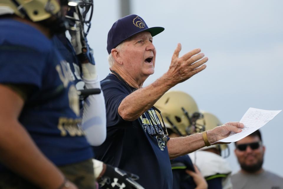 Defensive Coordinator Bob Burt works with his players on the La Joya Community High School Lobos football team as they practice on their field in Avondale Thursday, Aug. 18, 2022. 