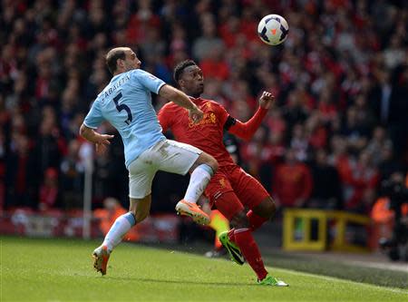 Manchester City's Pablo Zabaleta (L) challenges Liverpool's Daniel Sturridge during their English Premier League soccer match at Anfield in Liverpool, northern England April 13, 2014. REUTERS/Nigel Roddis