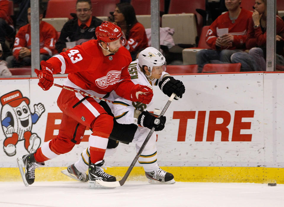 DETROIT, MI - FEBRUARY 14: Philip Larsen #36 of the Dallas Stars tres to get to the puck before Darren Helm #43 of the Detroit Red Wings at Joe Louis Arena on February 14, 2012 in Detroit, Michigan. (Photo by Gregory Shamus/Getty Images)