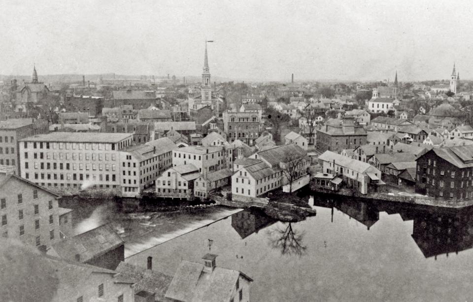 Slater Mill, with its dam on the Blackstone River, is at the center of an 1880s view of Pawtucket from St. Mary Antiochian Church.