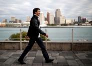 Liberal leader and Canadian Prime Minister Justin Trudeau walks with the city skyline of Detroit in the United States in the background, during an election campaign visit to Windsor