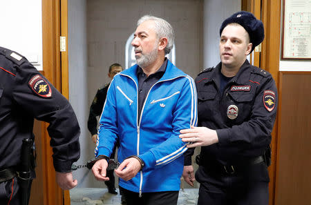 Partner in the Baring Vostok private equity group Vagan Abgaryan, who was detained on suspicion of fraud, is escorted inside a court building in Moscow, Russia February 15, 2019. REUTERS/Tatyana Makeyeva