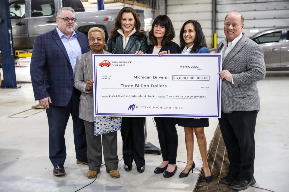 Jefferson Chevrolet General Manager Brian Tellier, (from the left) Detroit resident Annie Holt, Michigan Governor Gretchen Whitmer, Lincoln Park resident Karen Nash, Michigan Department of Insurance and Financial Services (DIFS) Director Anita Fox and Detroit Mayor Mike Duggan  pose with a check for three billion dollars made out to Michigan Drivers during a press conference announcing $400 automotive refund checks for Michigan drivers at Jefferson Chevrolet in Detroit  on Tuesday, March 8, 2022. 