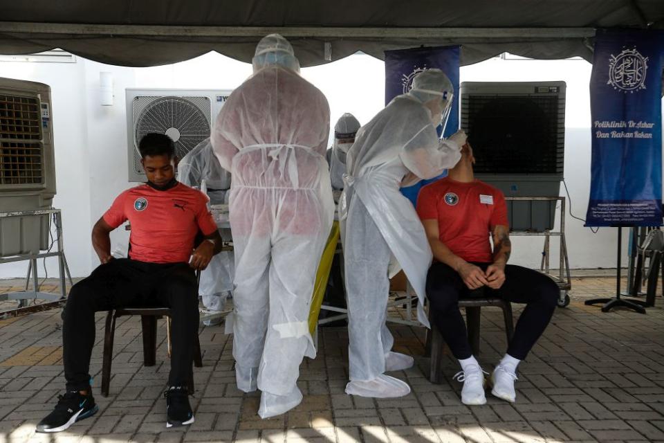 Healthcare workers collect swab samples to test for Covid-19 at the City Stadium in George Town July 5, 2021. — Picture by Sayuti Zainudin