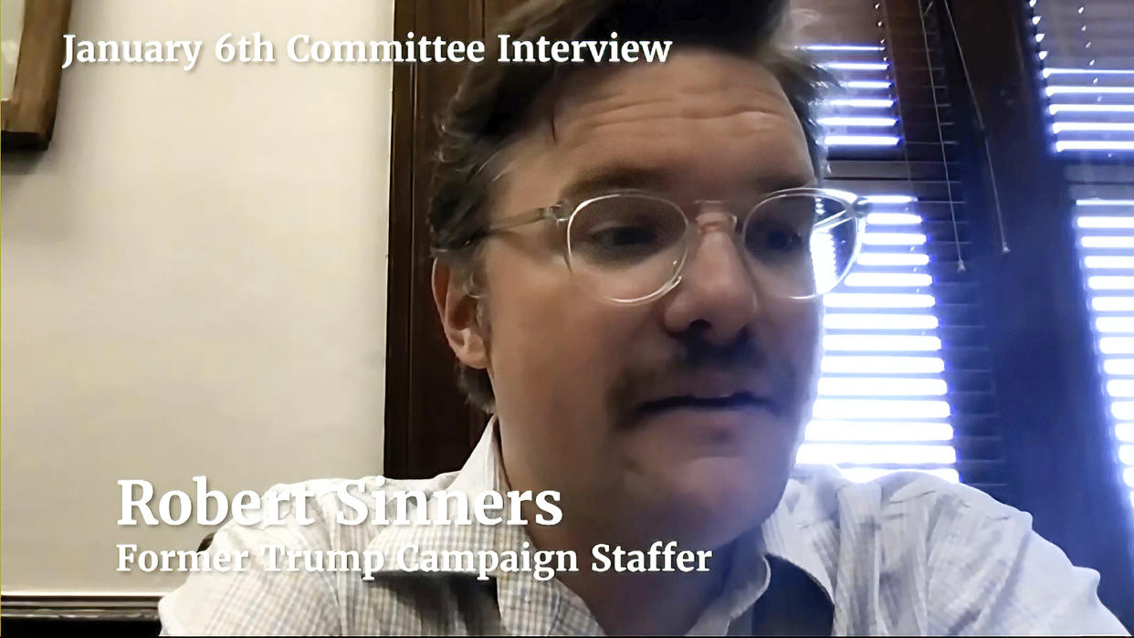 Robert Sinners in front of a window with open blinds, with an overlay script saying: January 6th Committee Interview, Robert Sinners, Former Trump Campaign Staffer.