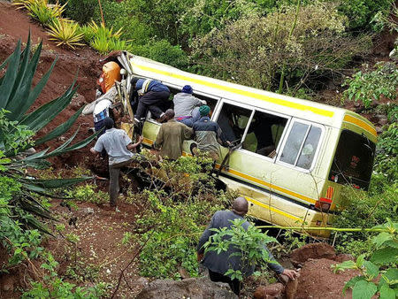 Residents attempt to rescue survivors at the scene of an accident that killed schoolchildren, teachers and a minibus driver at the Rhota village along the Arusha-Karatu highway in Tanzania's northern tourist region of Arusha, May 6, 2017. REUTERS/Emmanuel Herman