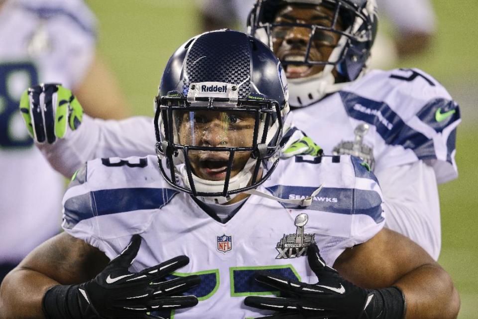 Seattle Seahawks outside linebacker Malcolm Smith (53) reacts after running back an interception for a touchdown against the Denver Broncos during the first half of the NFL Super Bowl XLVIII football game, Sunday, Feb. 2, 2014, in East Rutherford, N.J. (AP Photo/Chris O'Meara)