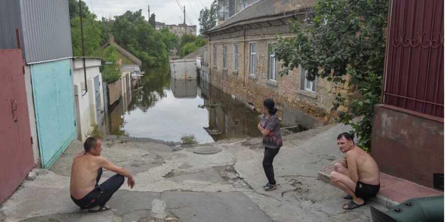 Residents of Kherson near the flooded houses