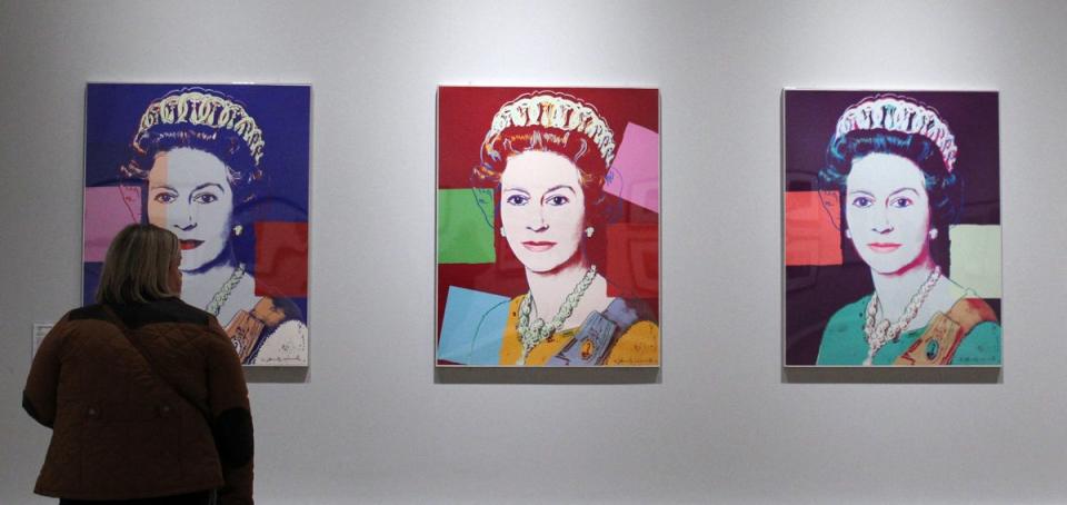 A visitor views silkscreen prints of Queen Elizabeth II from Reigning Queens by artist Andy Warhol at the Ulster Museum in Belfast on January 14, 2012 (AFP via Getty Images)