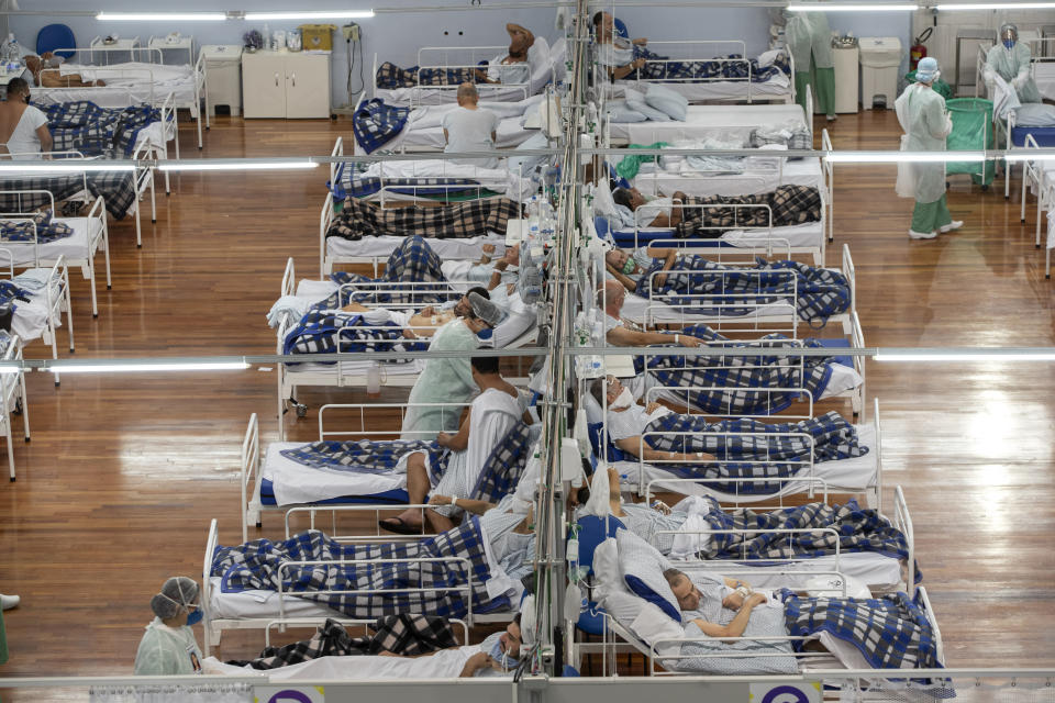 COVID-19 patients lie on beds in a field hospital built inside a gym in Santo Andre, on the outskirts of Sao Paulo, Brazil, Tuesday, June 9, 2020. (AP Photo/Andre Penner)