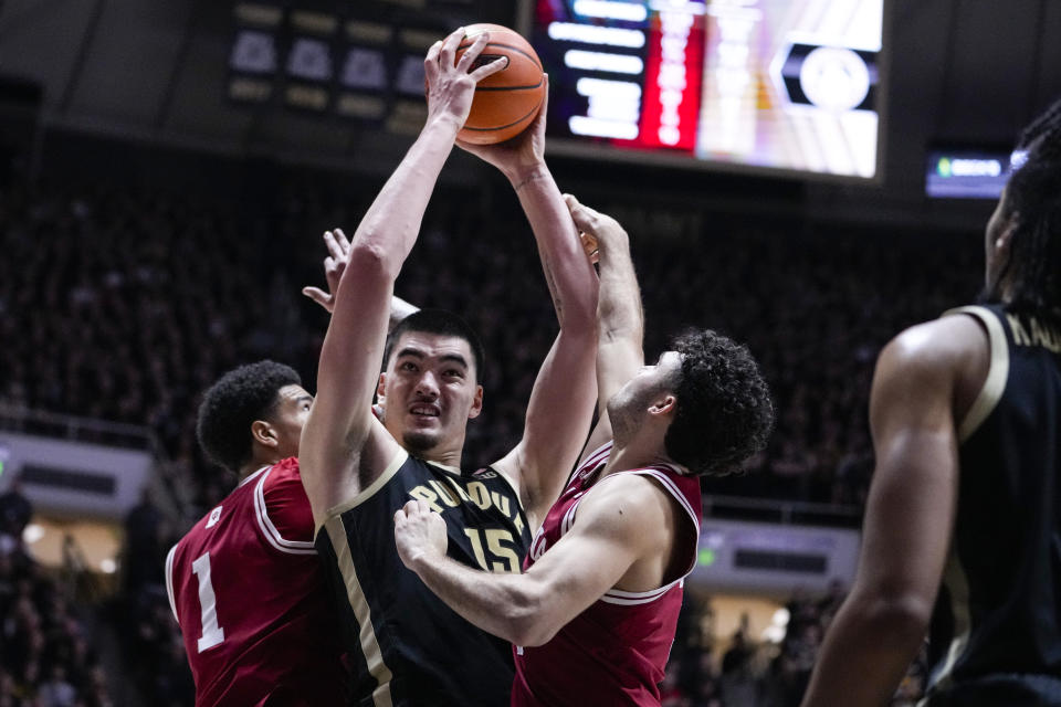 Purdue center Zach Edey (15) is fouled as he shoots between Indiana center Kel'el Ware (1) and guard Anthony Leal (3) during the second half of an NCAA college basketball game in West Lafayette, Ind., Saturday, Feb. 10, 2024. (AP Photo/Michael Conroy)