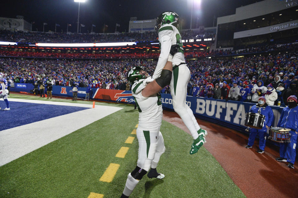 New York Jets' Keelan Cole, top, celebrates his touchdown during the first half of an NFL football game against the Buffalo Bills, Sunday, Jan. 9, 2022, in Orchard Park, N.Y. (AP Photo/Adrian Kraus)