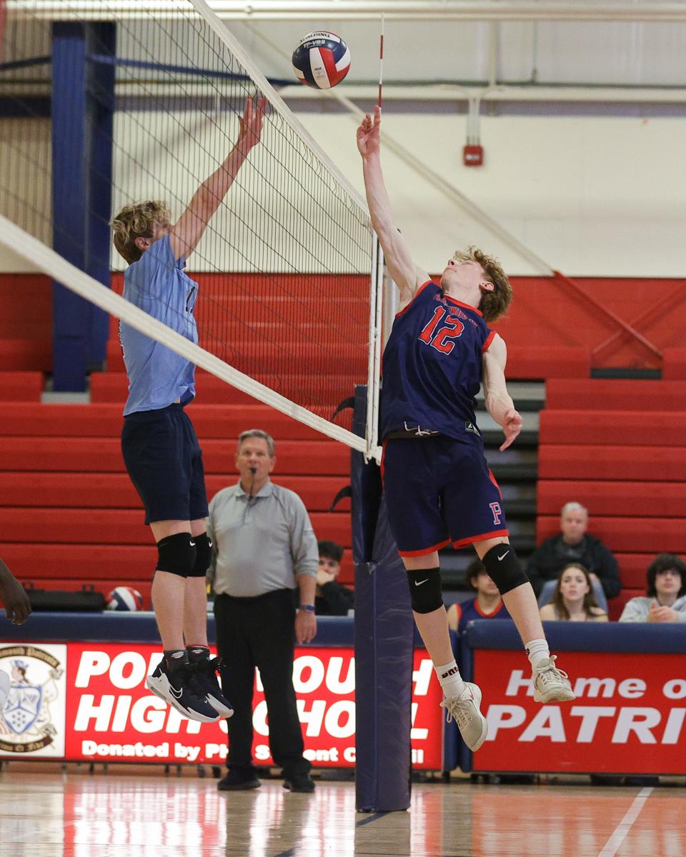 Portsmouth's Will Voute rises near the net and tips the ball over a Johnston player's block attempt during the Panthers win over the Patriots on Monday.