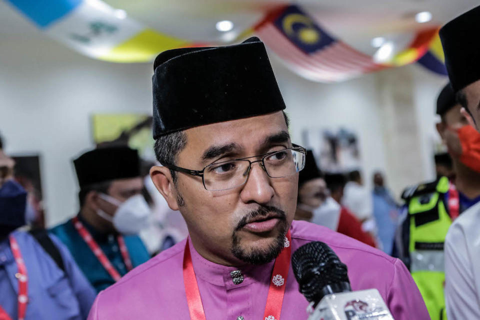 Umno Youth chief Datuk Asyraf Wajdi Dusuki speaks to reporters at Umno’s extraordinary general meeting (EGM) at the World Trade Centre in Kuala Lumpur May 15, 2022. — Picture by Firdaus Latif