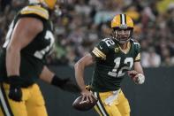 Green Bay Packers' Aaron Rodgers scrambles during the second half of an NFL football game against the Detroit Lions Monday, Sept. 20, 2021, in Green Bay, Wis. (AP Photo/Morry Gash)