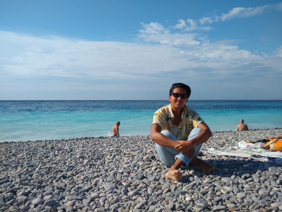 tino roco on beach with water in background