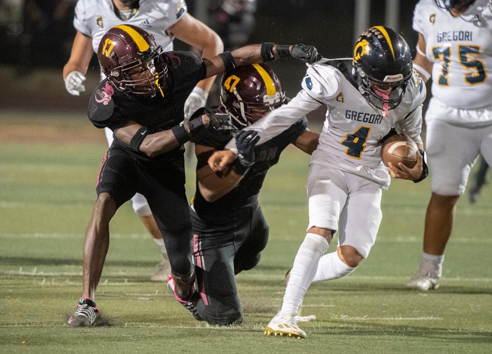 Edison's Anthony Billberry, left, and Zeke Conley tackled Gregori's Emmanuel Vasquez during Sac-Joaquin Section first round playoff game at Edison's Magnasco Stadium in Stockton on Nov. 3, 2023.