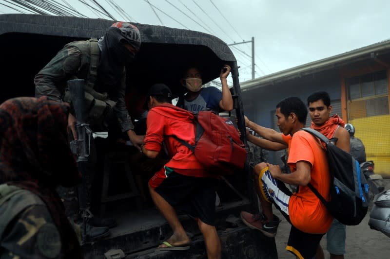 Residents living near the erupting Taal Volcano are evacuated in Agoncillo, Batangas City