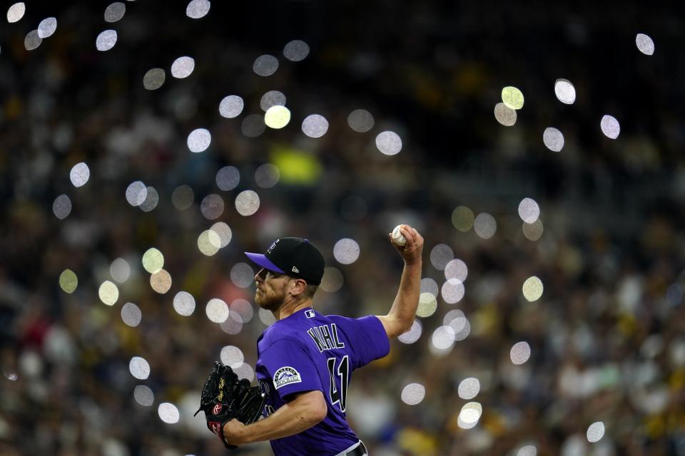 Colorado Rockies starting pitcher Chad Kuhl works against a San Diego Padres batter as fans turn on lights on their phones during the sixth inning of a baseball game Wednesday, Aug. 3, 2022, in San Diego. (AP Photo/Gregory Bull)