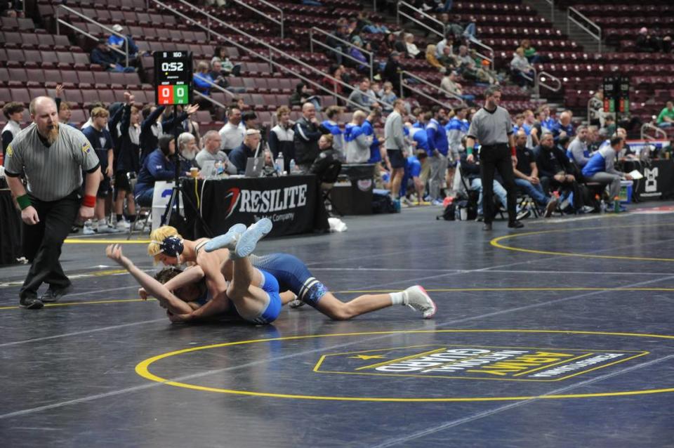 Bald Eagle Area’s Mason Reese finishes off a takedown on Reynolds’ Emery Johnson in their 114-pound bout of the Eagles’ 27-25 loss on Friday in the PIAA Class 2A dual championships consolation first round. Reese snuck past Johnson, 4-2.
