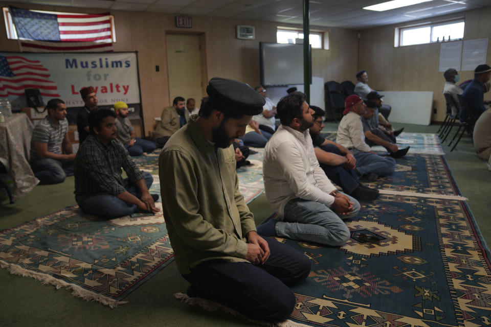 Men of the Zion Ahmadiyya Muslim community attend Friday prayer in Zion, Ill., on Friday, Sept. 16, 2022. The Ahmadi community will move from a suburban house, which was converted into a community center where the members pray, to a new multimillion dollar mosque in Zion. The Fath-e-Azeem mosque will be inaugurated on Saturday, Oct. 1, 2022. (AP Photo/Jessie Wardarski)