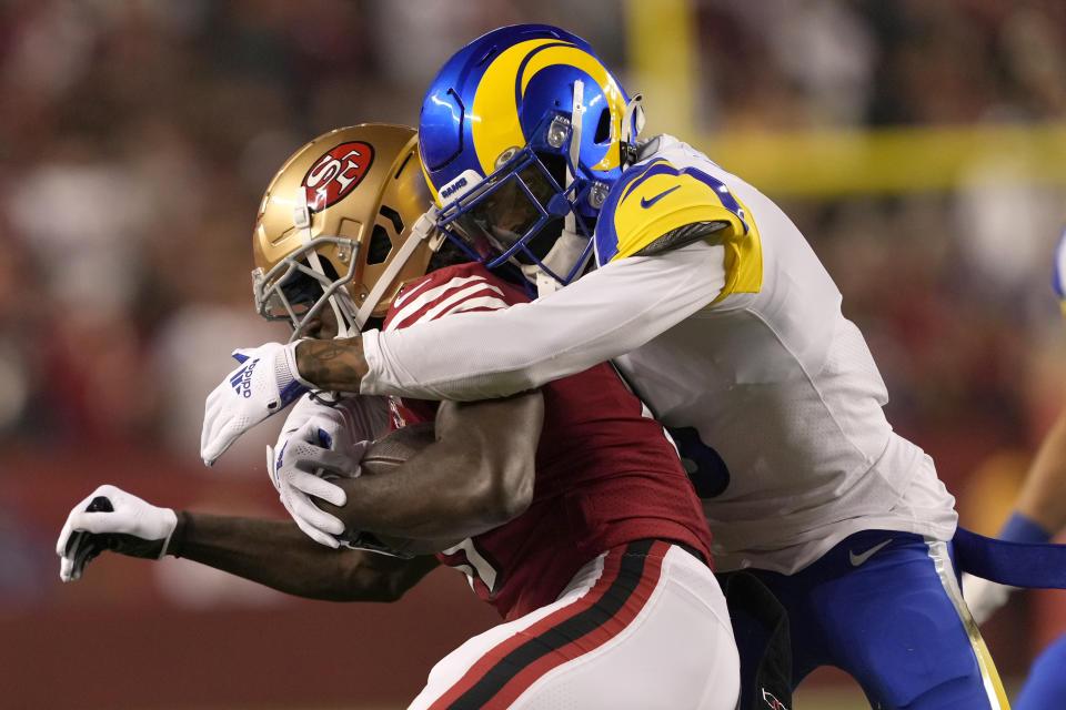 San Francisco 49ers wide receiver Brandon Aiyuk, left, is tackled by Los Angeles Rams cornerback Jalen Ramsey during the first half of an NFL football game in Santa Clara, Calif., Monday, Nov. 15, 2021. (AP Photo/Tony Avelar)