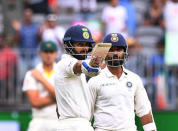 India's captain Virat Kohli raises his bat after scoring his half century on day two of the second test match between Australia and India at Perth Stadium in Perth, Australia, December 15, 2018. AAP/Dave Hunt/via REUTERS