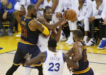 Jun 1, 2017; Oakland, CA, USA; Golden State Warriors forward Kevin Durant (35) passes the ball away from Cleveland Cavaliers forward LeBron James (23) in the first half of the NBA Finals at Oracle Arena. Mandatory Credit: Cary Edmondson-USA TODAY Sports