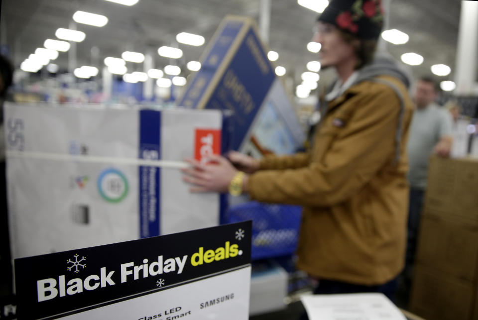 People wait in line to buy televisions as they shop during an early Black Friday sale at a Best Buy store on Thanksgiving Day Thursday, Nov. 22, 2018, in Overland Park, Kan. (AP Photo/Charlie Riedel)