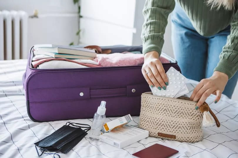 Woman packing suitcase