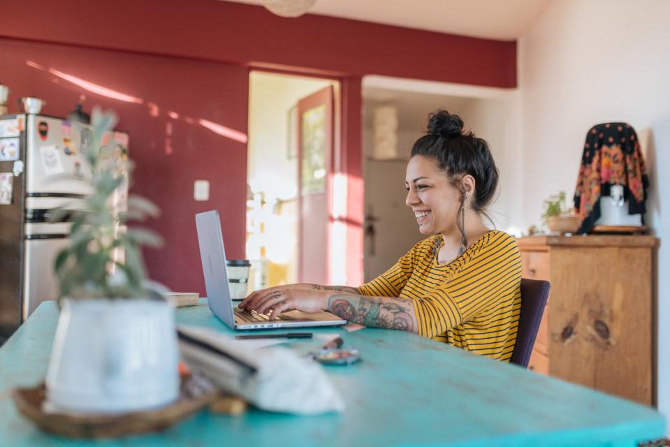 A person uses a laptop computer at home.