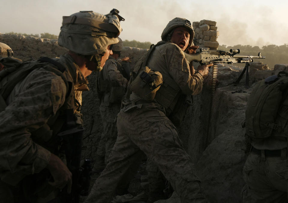 <p>U.S. marines fire during a Taliban ambush as they carry out an operation to clear an area in Helmand province, Oct. 9, 2009. (Photo: Asmaa Waguih/Reuters) </p>