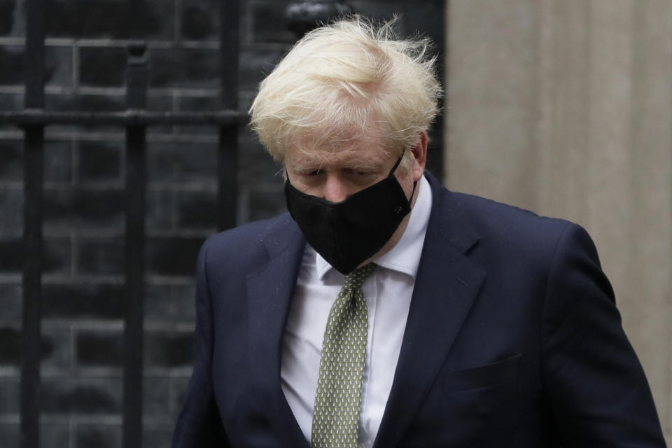 Britain's Prime Minister Boris Johnson leaves Downing Street to attend parliament in London, Monday, Oct. 12, 2020. British Prime Minister Boris Johnson is expected to announce in Parliament on Monday a three-tier local lockdown system, formally known as "Local COVID Alert Levels," for England, his office said. (AP Photo/Kirsty Wigglesworth)