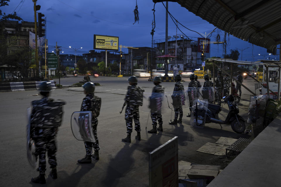 Indian paramilitary soldiers stand guard to enforce curfew in Imphal, capital of the northeastern Indian state of Manipur, Monday, June 19, 2023. Deadly clashes, which have left at least 130 dead by the authorities’ conservative estimates, persist despite the army’s presence in the state that now remains divided in two ethnic zones. The two warring factions have also formed armed militias and isolated villages are still raked with gunfire. More than 60,000 people have fled to packed relief camps. (AP Photo/Altaf Qadri)