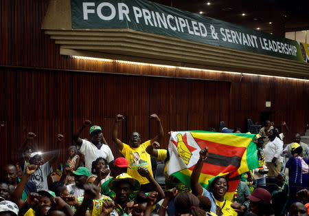 Supporters of President Emmerson Mnangagwa's ruling ZANU-PF party react to the results of a constitutional court hearing challenging his electoral victory in Harare, Zimbabwe August 24, 2018. REUTERS/Philimon Bulawayo