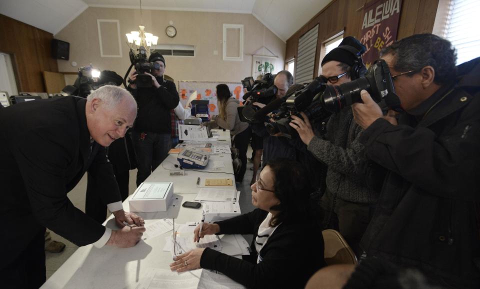 Illinois Gov. Pat Quinn talks to election judges before voting in the Illinois primary at Galewood Community Church in Chicago, Tuesday, March 18, 2014. Quinn, who was Blagojevich's lieutenant governor and assumed the office after his boss was booted amid a corruption scandal, was facing lesser-known challenger Tio Hardiman in Tuesday's primary. Quinn, seeking his second full term, was expected to easily win the Democratic nomination. (AP Photo/Paul Beaty)