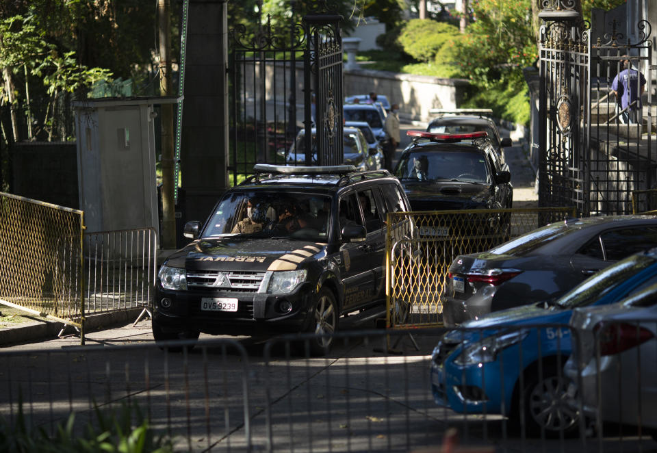 Federal police leave Laranjeiras Palace, the official residence of Rio de Janeiro Gov. Wilson Witzel, in Rio de Janeiro, Brazil, Tuesday, May 26, 2020. Brazil's Federal Police raided the governor's official residence on Tuesday to carry out searches, part of an investigation into the embezzlement of public resources in the state's response to the COVID-19 pandemic. (AP Photo/Silvia Izquierdo)