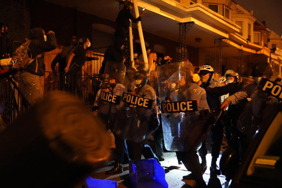 Police officers move in formation during a protest in response to the police shooting of Walter Wallace Jr., Monday, Oct. 26, 2020, in Philadelphia. Police officers fatally shot the 27-year-old Black man during a confrontation Monday afternoon in West Philadelphia that quickly raised tensions in the neighborhood. (Jessica Griffin/The Philadelphia Inquirer via AP)