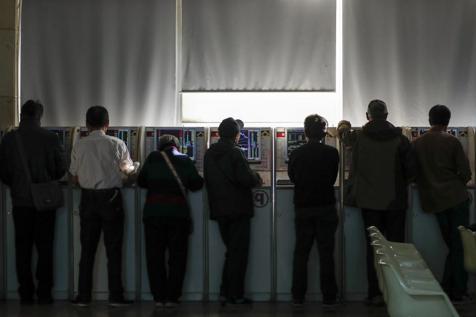 Chinese investors check stock prices at a brokerage house in Beijing, Thursday, Nov. 28, 2019. Asian shares were mostly lower on Thursday after President Donald Trump signed a bill expressing support for human rights in Hong Kong. (AP Photo/Andy Wong)