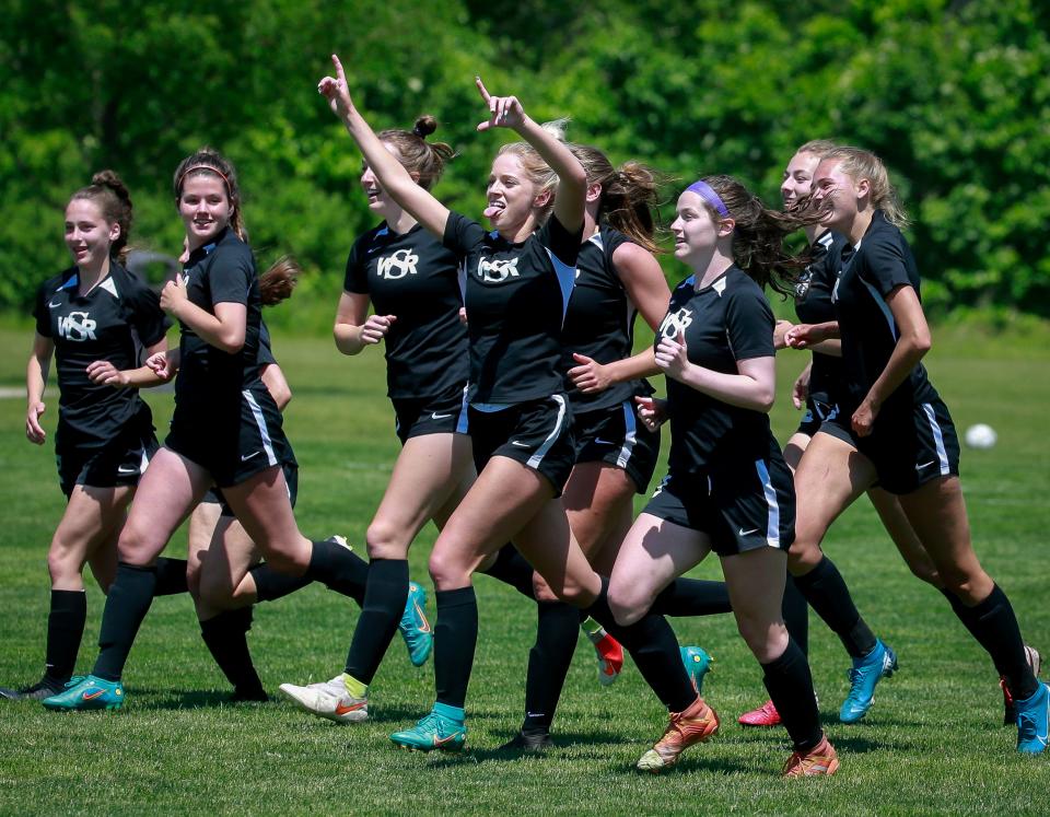 Members of the Waverly-Shell Rock girls soccer team celebrate a 1-0 win over Norwalk.