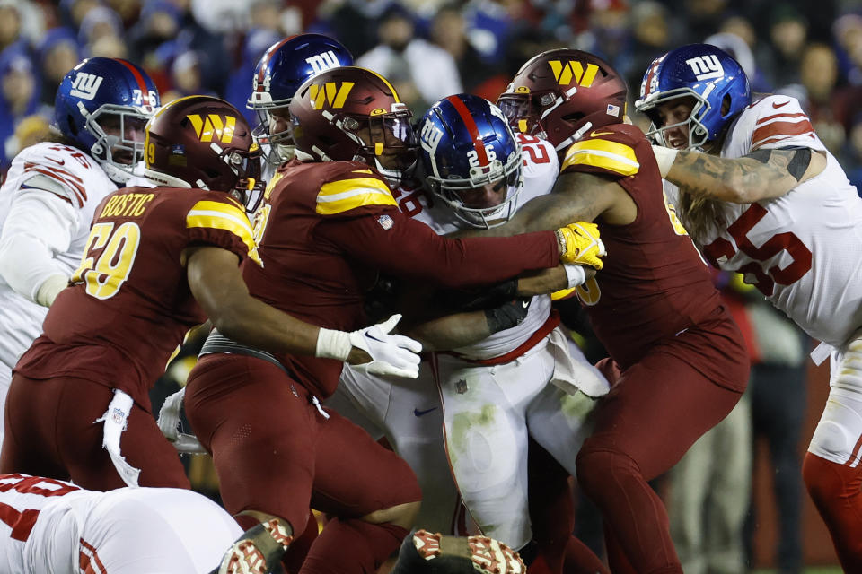 New York Giants running back Saquon Barkley (26) is tackled by Washington Commanders defensive tackle <a class="link " href="https://sports.yahoo.com/nfl/players/30130" data-i13n="sec:content-canvas;subsec:anchor_text;elm:context_link" data-ylk="slk:Jonathan Allen;sec:content-canvas;subsec:anchor_text;elm:context_link;itc:0">Jonathan Allen</a> (93) and Commanders defensive tackle <a class="link " href="https://sports.yahoo.com/nfl/players/30983" data-i13n="sec:content-canvas;subsec:anchor_text;elm:context_link" data-ylk="slk:Daron Payne;sec:content-canvas;subsec:anchor_text;elm:context_link;itc:0">Daron Payne</a> (94). Mandatory Credit: Geoff Burke-USA TODAY Sports