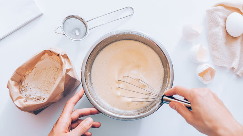 Hands mixing batter 