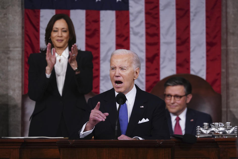 President Joe Biden delivers the State of the Union address to a joint session of Congress at the Capitol, Thursday, March 7, 2024, in Washington. Standing at left is Vice President Kamala Harris and seated at right is House Speaker Mike Johnson, R-La. (Shawn Thew/Pool via AP)