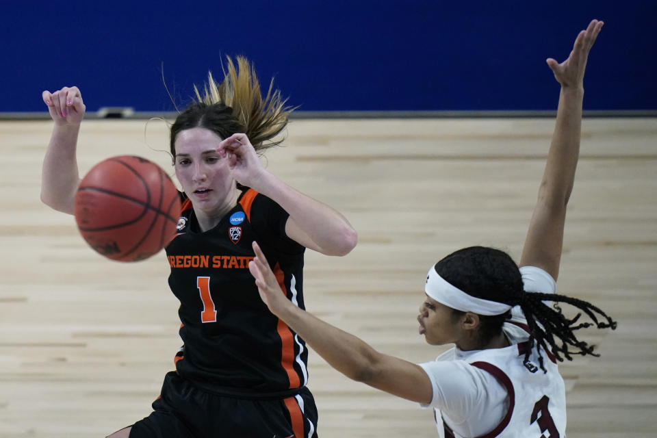 Oregon State guard Aleah Goodman (1) eyes a rebound ahead of South Carolina guard Destanni Henderson (3) during the second half of a college basketball game in the second round of the women's NCAA tournament at the Alamodome in San Antonio, Tuesday, March 23, 2021. (AP Photo/Eric Gay)