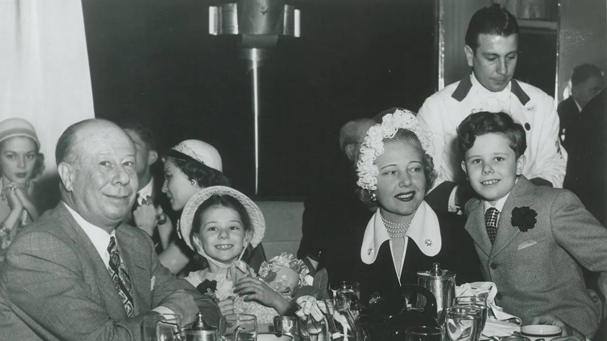 Bert Lahr with his family. sitting down at a restaurant.