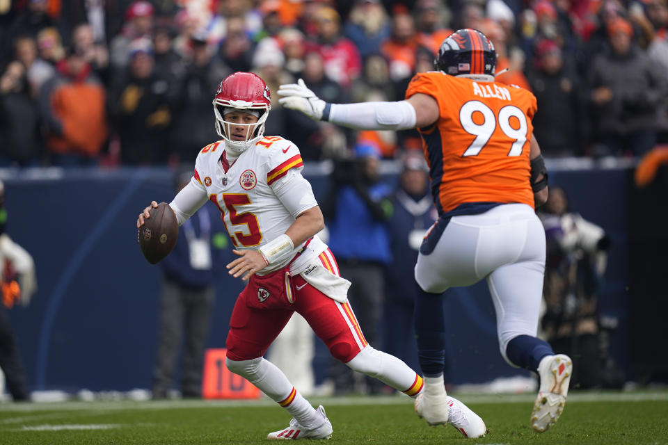 Kansas City Chiefs quarterback Patrick Mahomes (15) scrambles as Denver Broncos defensive end Zach Allen (99) defends during the first half of an NFL football game Sunday, Oct. 29, 2023, in Denver. (AP Photo/Jack Dempsey)
