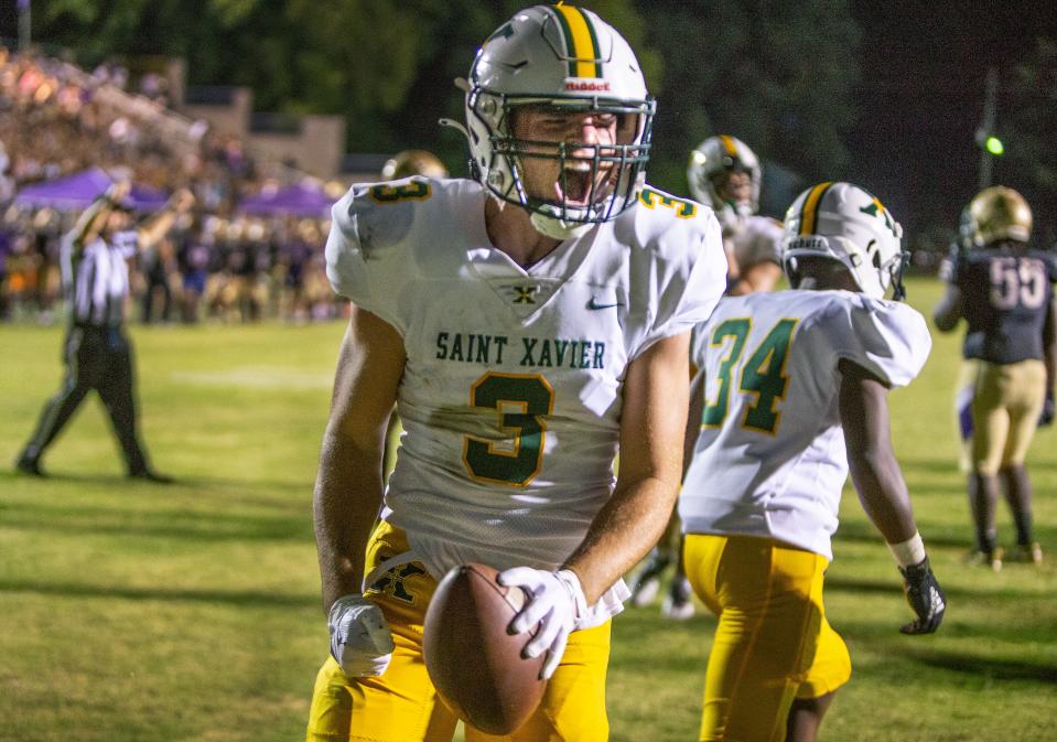 St. Xavier's Adam Boone celebrates in the endzone after scoring a touchdown against Louisville Male High to make the score 23-10. Sept. 2, 2022